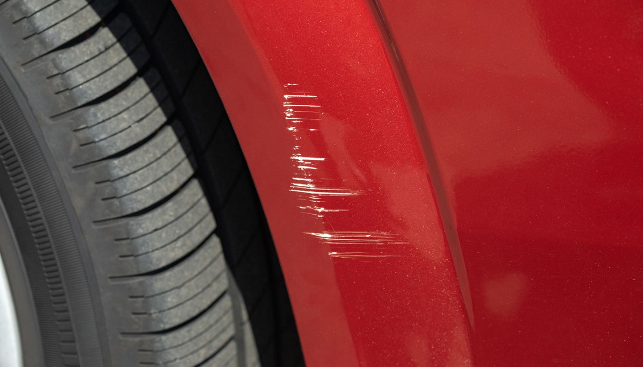 Scratch on the front of the car's wing in a car repair shop.