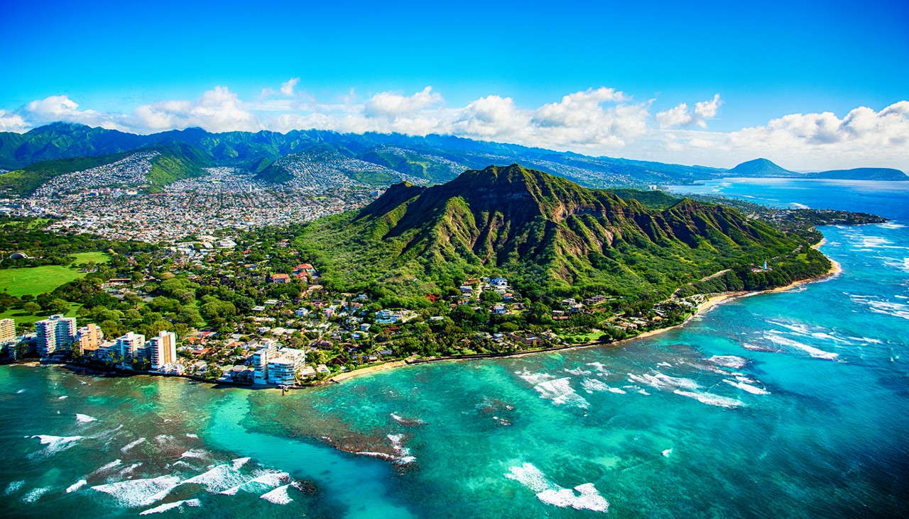 The dormant volcano known as Diamond Head located adjacent to downtown Honlulu, Hawaii, as shot from an altitude of about 1500 feet over the Pacific Ocean.